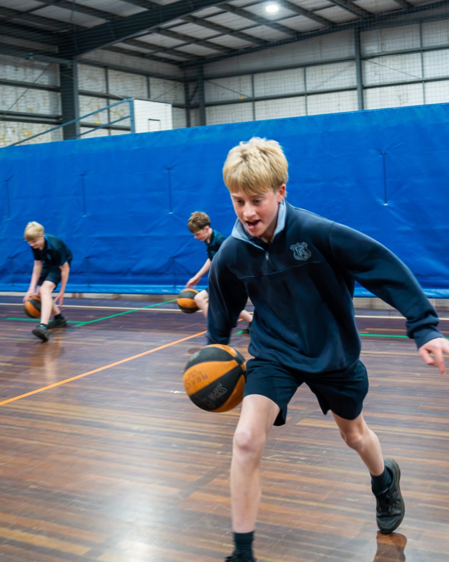 Student dribbling low in a drill