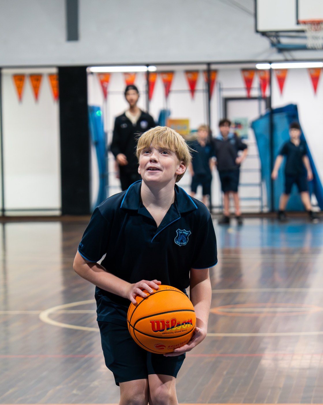 Young student smiling with a basketball
